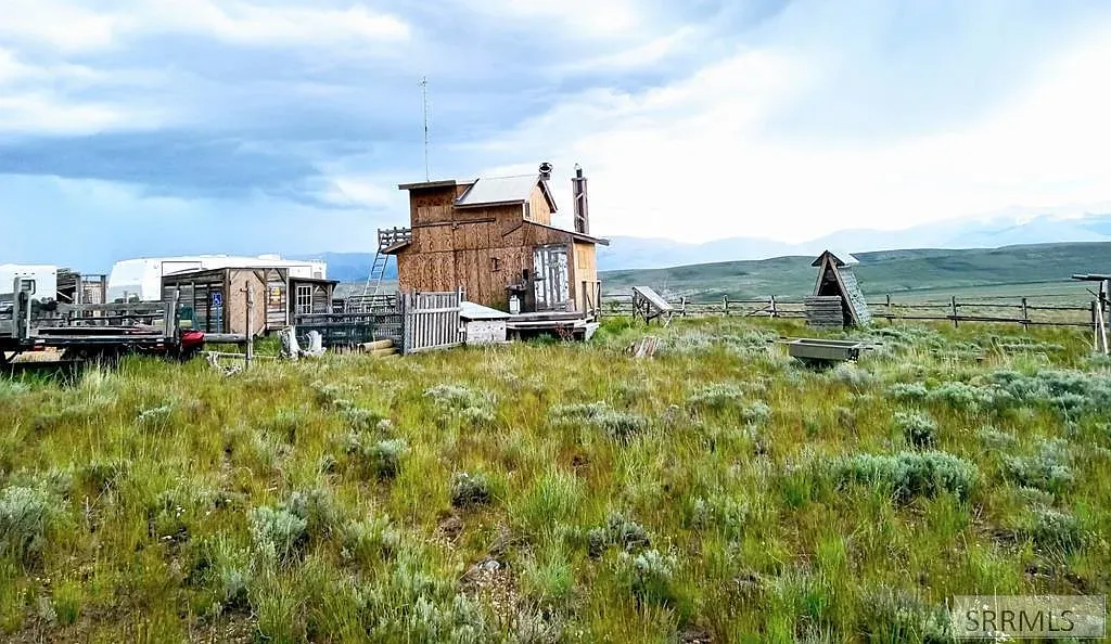 "Here’s the charming little cabin—it has such a rustic vibe! You can see the spacious yard all around it, perfect for outdoor gatherings or just enjoying the peaceful surroundings."