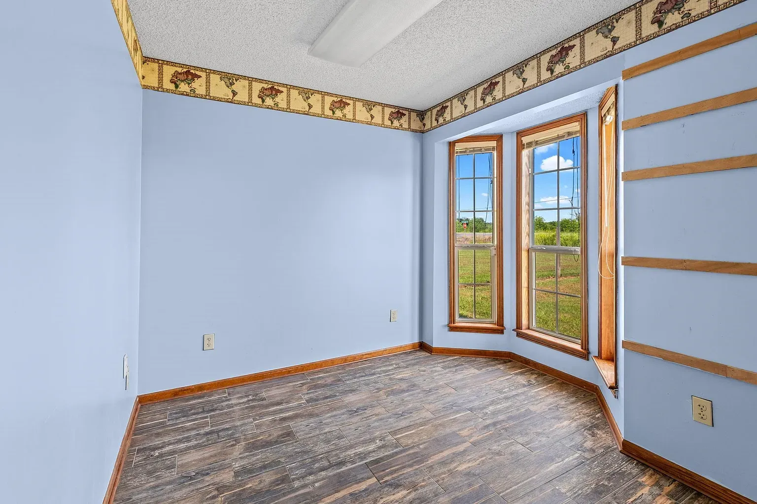 Those arched windows are the moment. Blue walls, warm wood trim.
