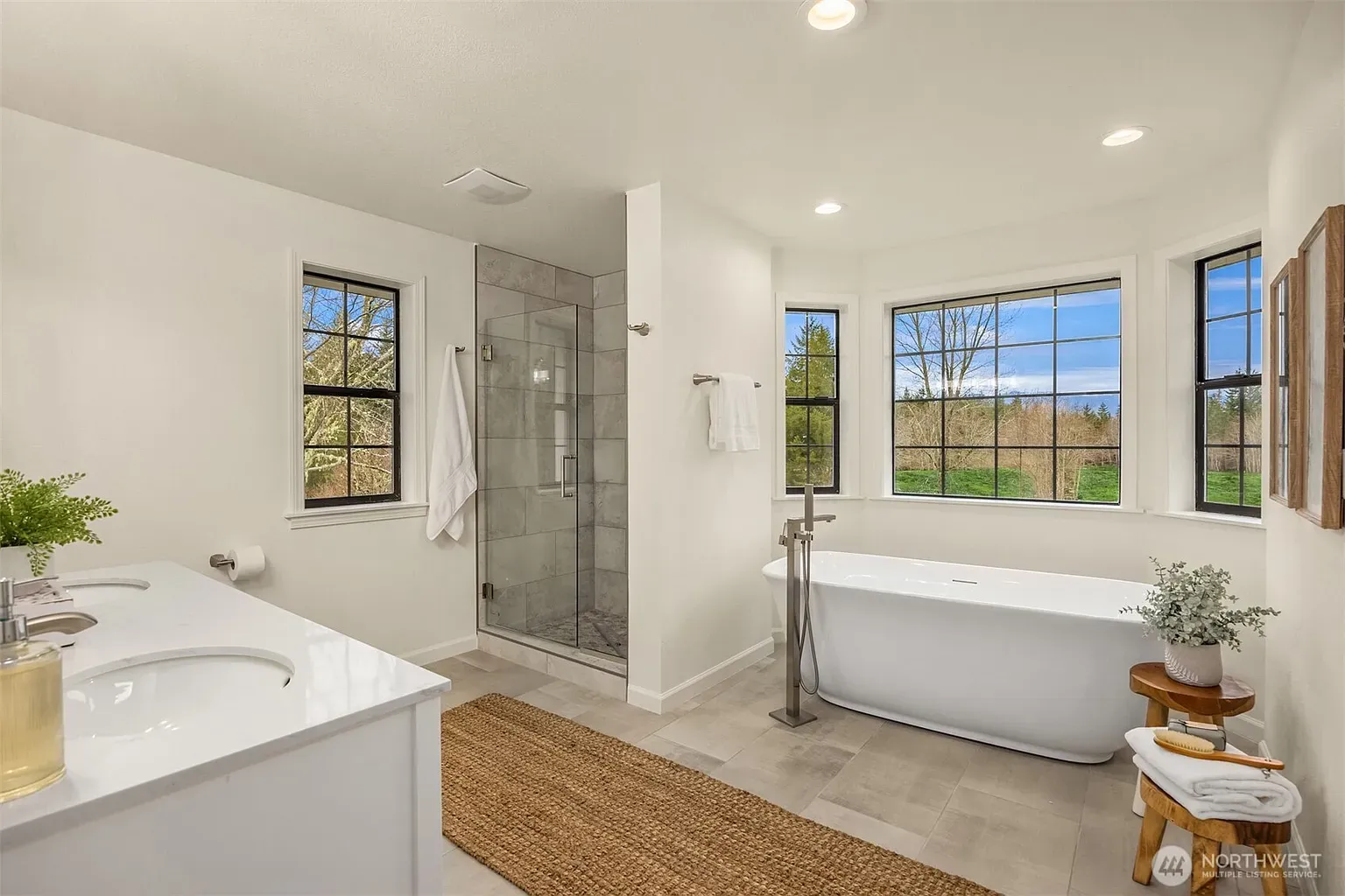 Crisp white bath, frameless glass shower — minimal without feeling sterile.