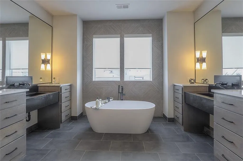 Spa bath moment. freestanding tub, herringbone walls, glassy light. Love it, but price tho?