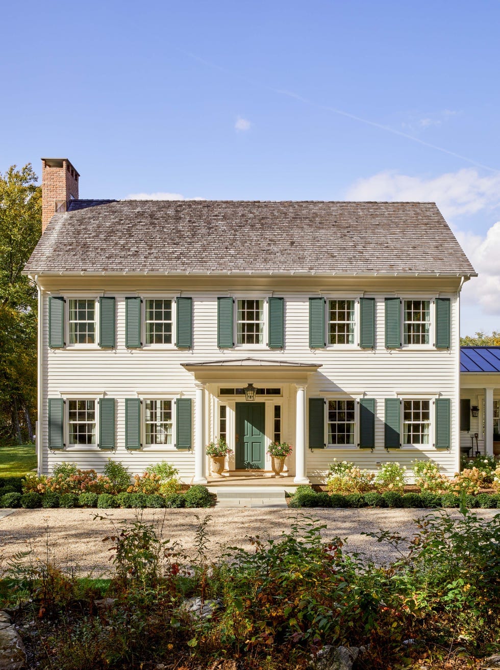 "Classic Colonial Charm With Green Shutters and a Welcoming Front Entrance That Perfectly Balances Traditional Architecture and Modern Landscaping!"
