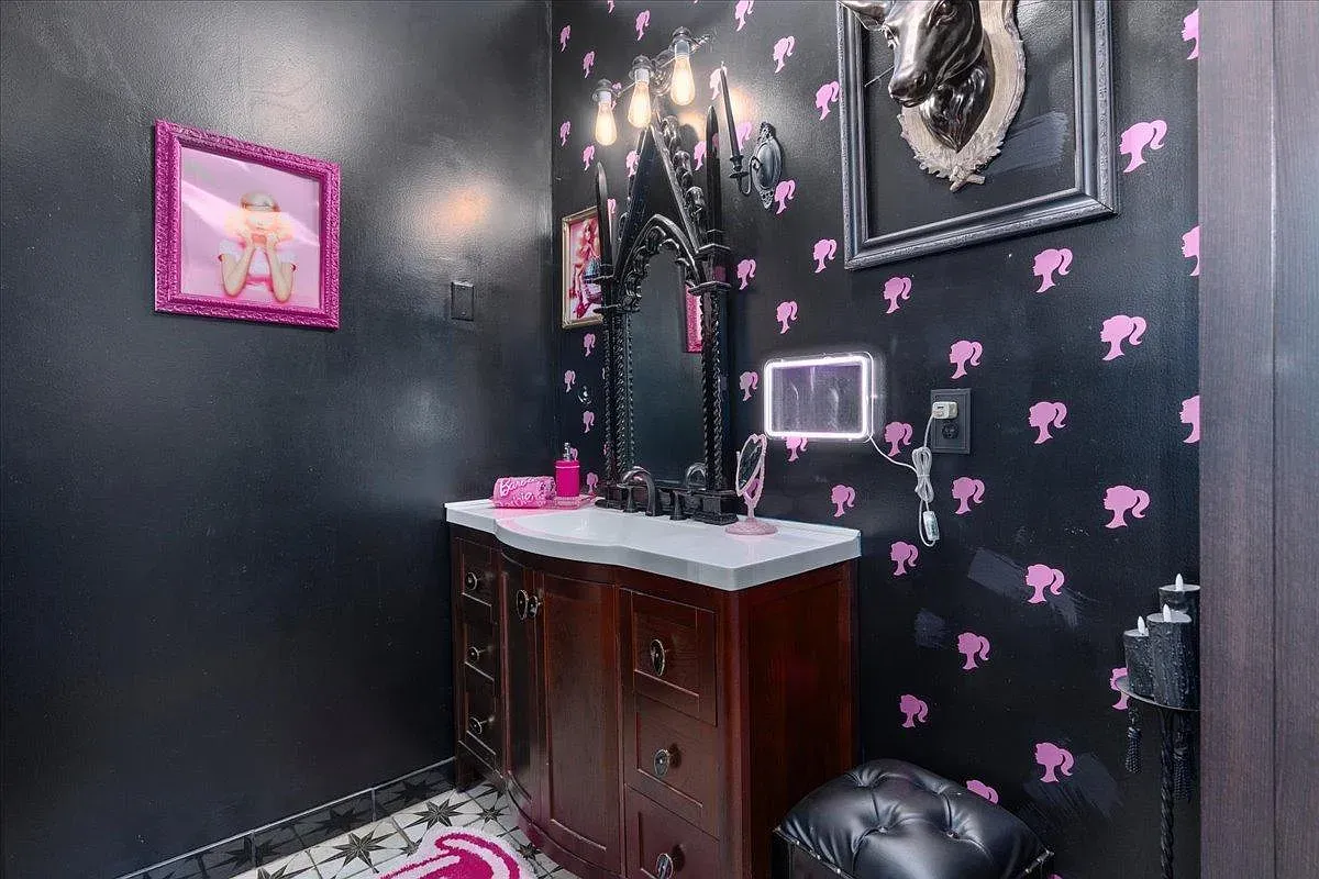 ## Black bathroom goes glam with pink poodle silhouettes; it’s quirky, bold, and actually pretty fun for a quick mirror selfie.
