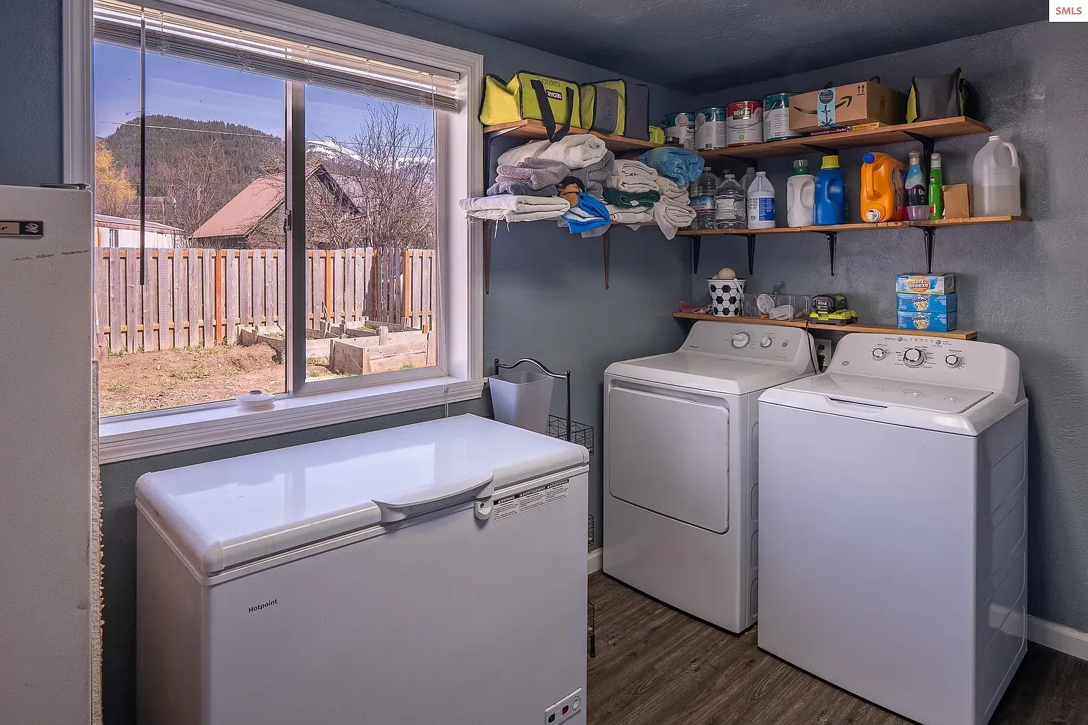 Laundry room with blue walls and wood floors. Sink and folding space, yes please.