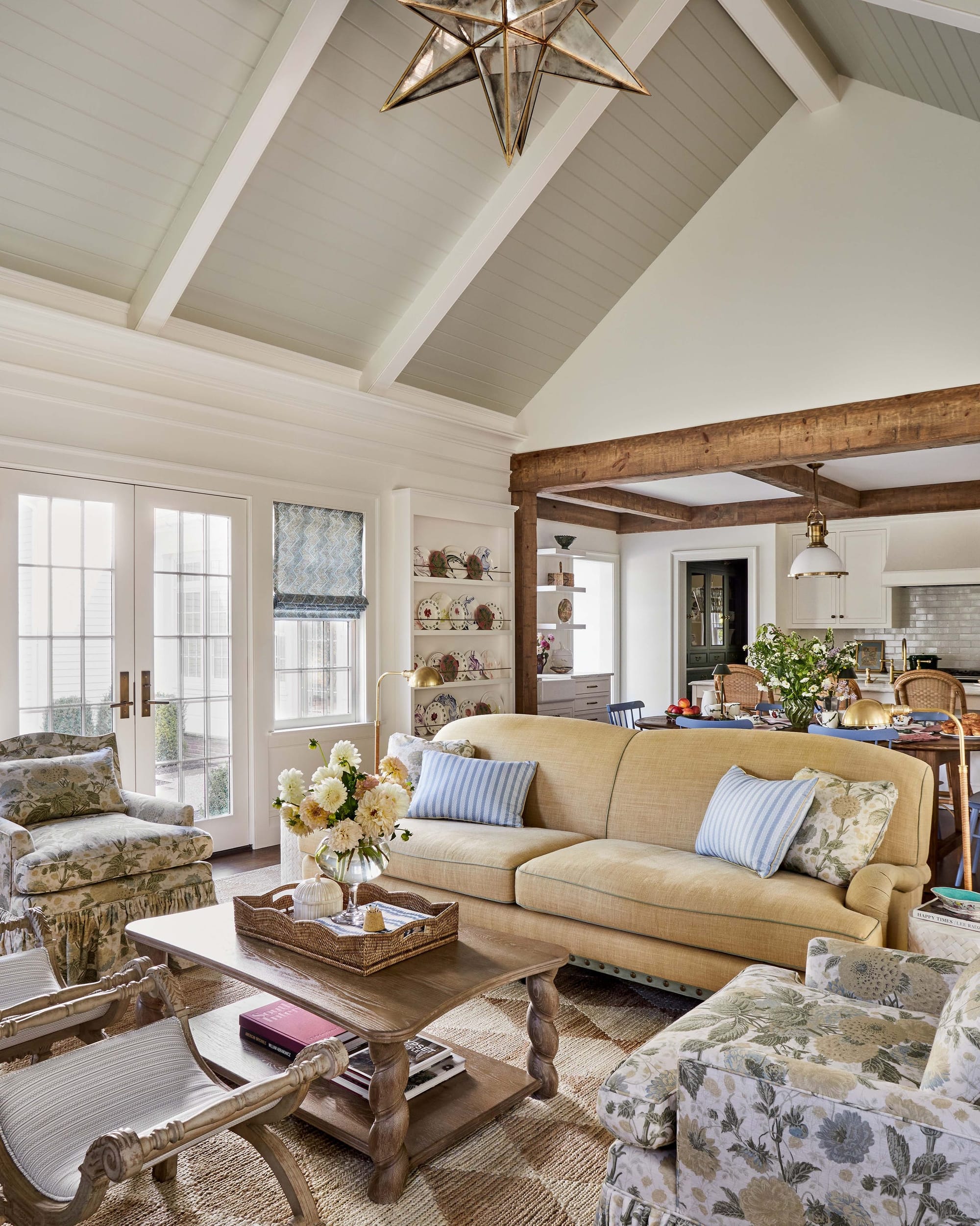 "Vaulted ceilings and rustic beams create a perfect blend of coastal charm and farmhouse elegance in this sun-drenched living space!"