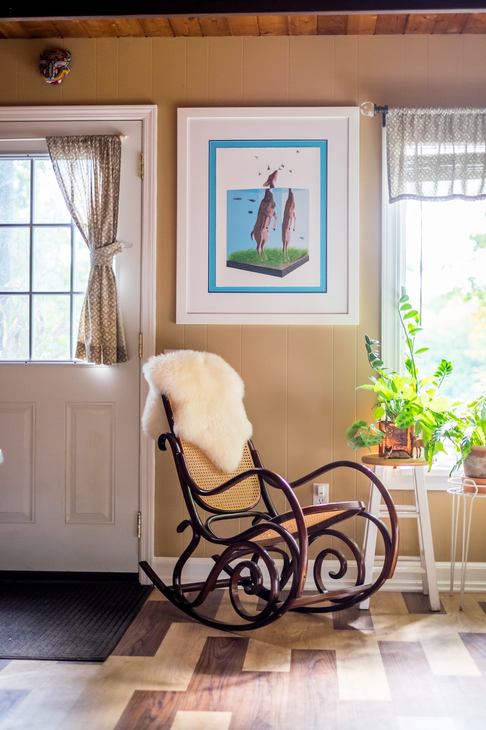 "Cozy reading nook with vintage rocker and artistic flair!"
