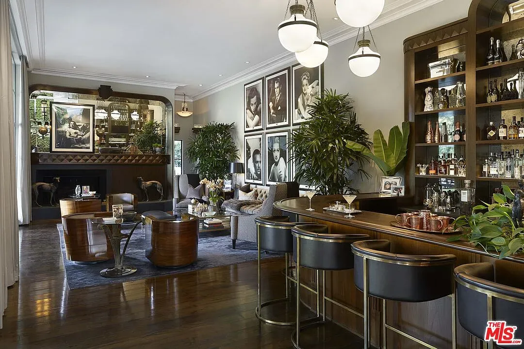 And then a lounge with a bar—black stools, glossy wood, low lighting.