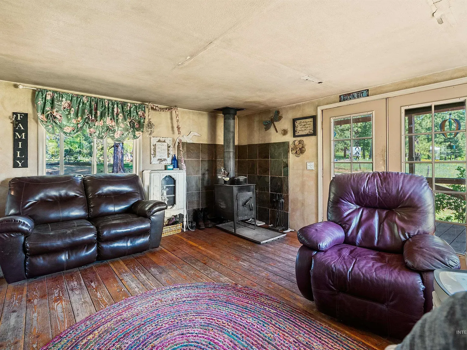 Two dark leather recliners facing each other. Feels settled.