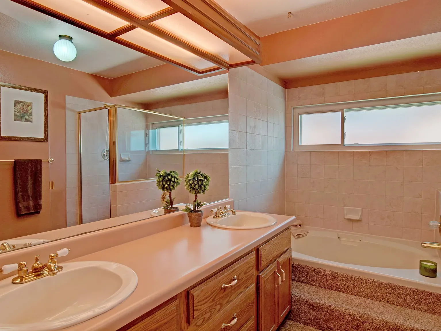 Peach bathroom with a chunky double vanity. Are peach walls coming back?
