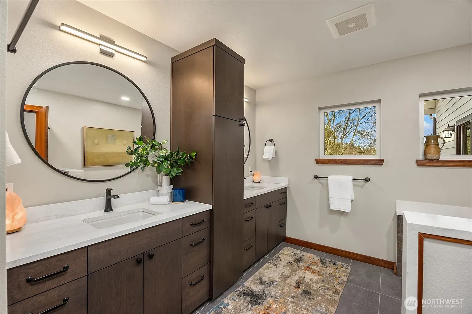 Soft gray bathroom, dark double vanity. Straightforward, easy to live with.