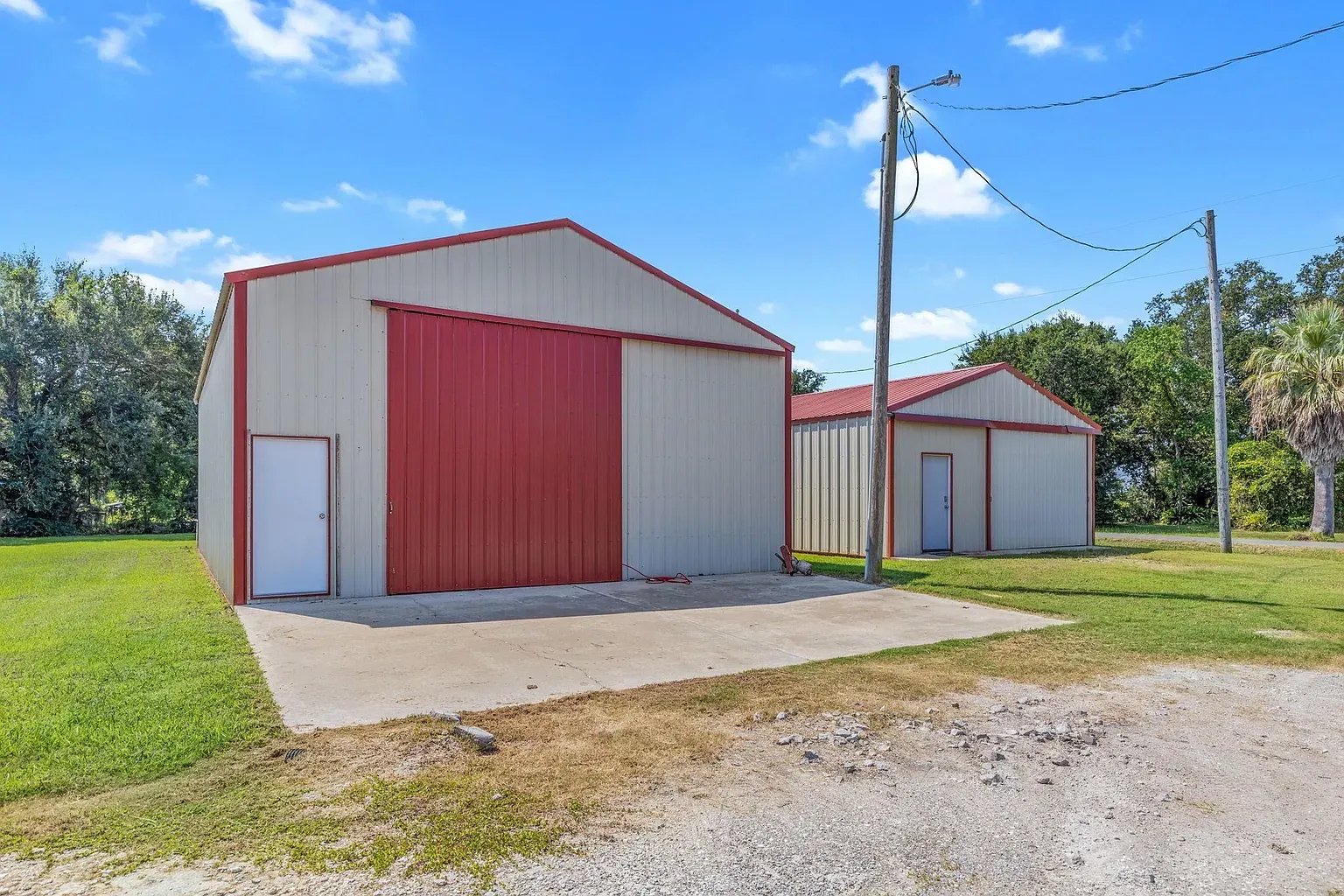Okay, this is wild — twin metal barns, funky-looking colors, bold red door.
