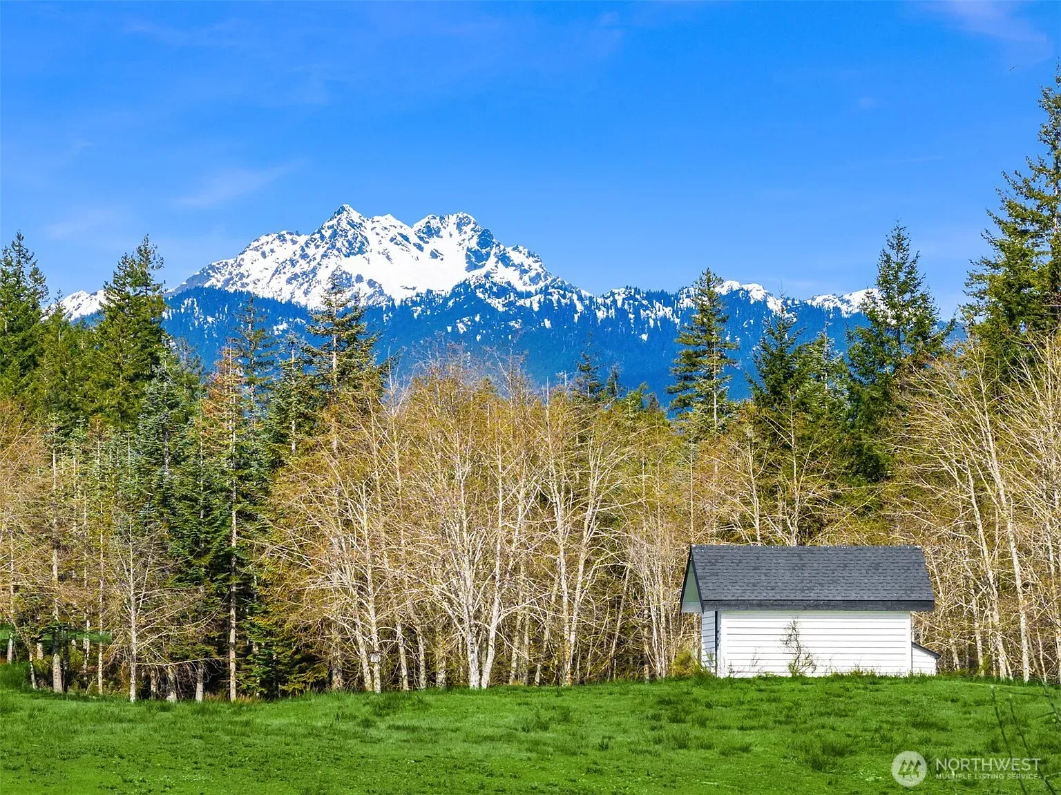Then this white cottage, simple lines, mountains casually flexing in the background.