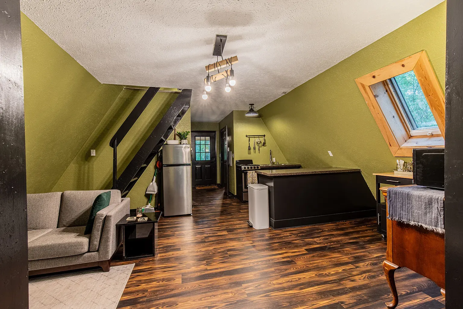 Open layout, rich olive again, dark wood trim. Consistent, not boring.