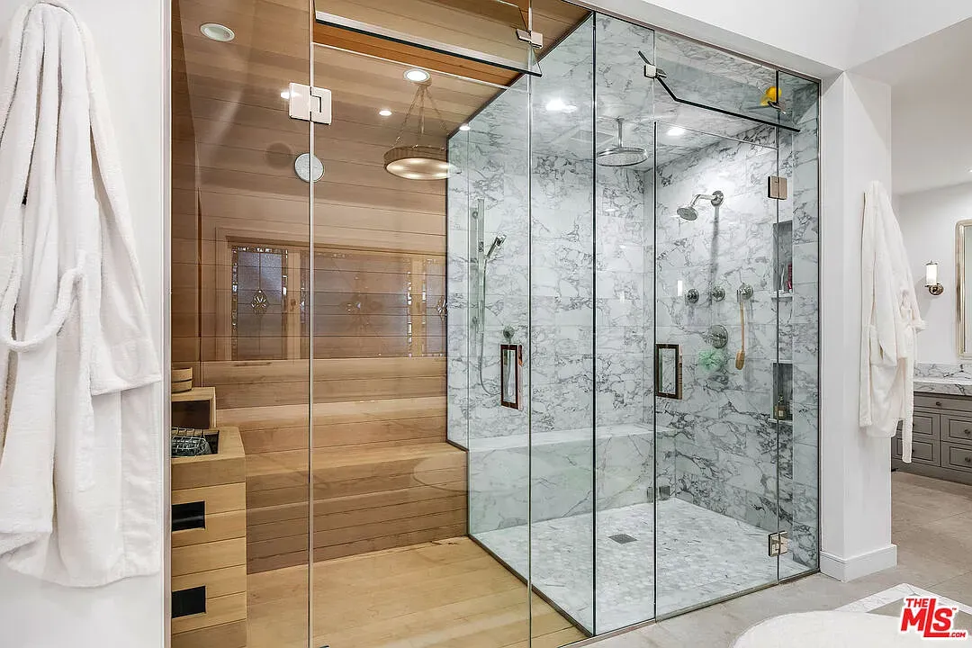 Shower’s basically a glass cube spa. Marble details, super clean lines.