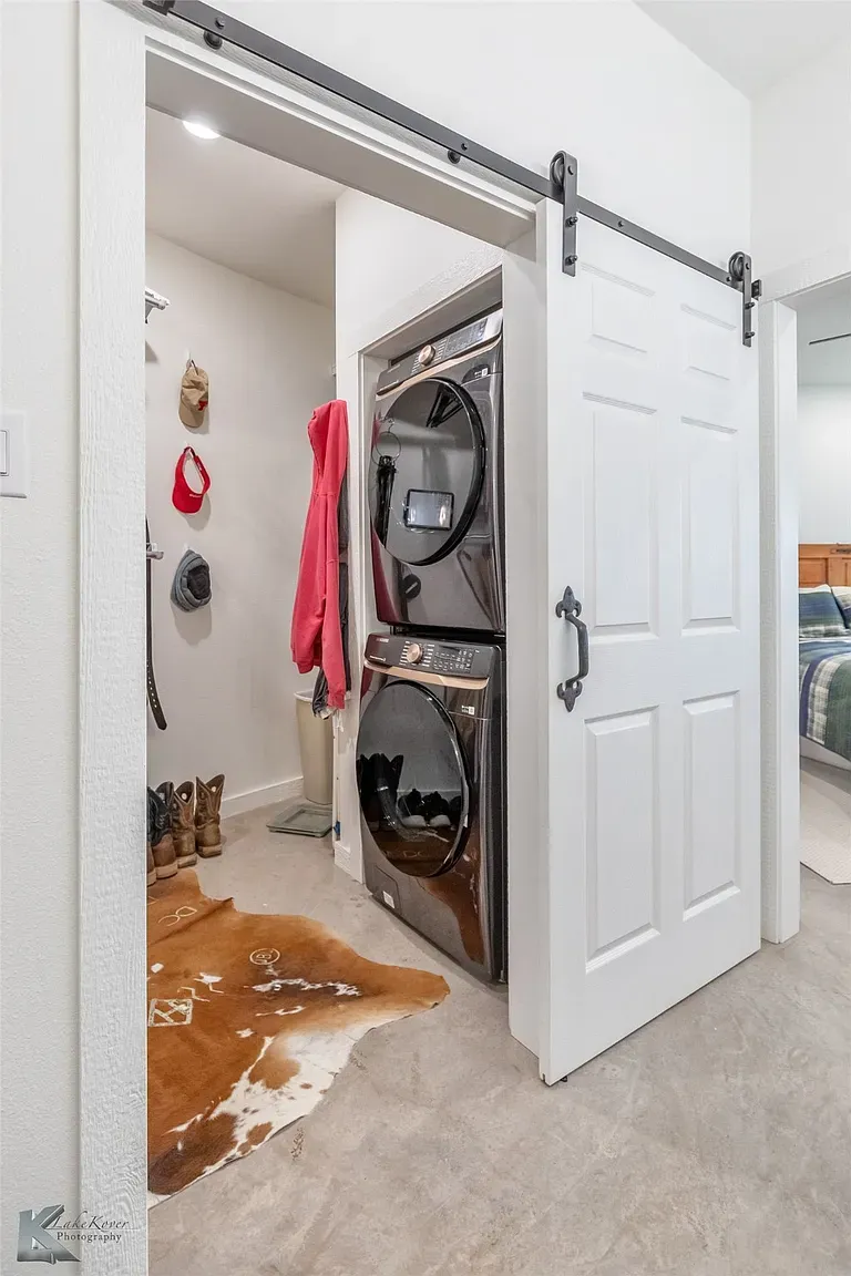 Here's the laundry nook—stacked black units in bright white. Tiny but sharp.
