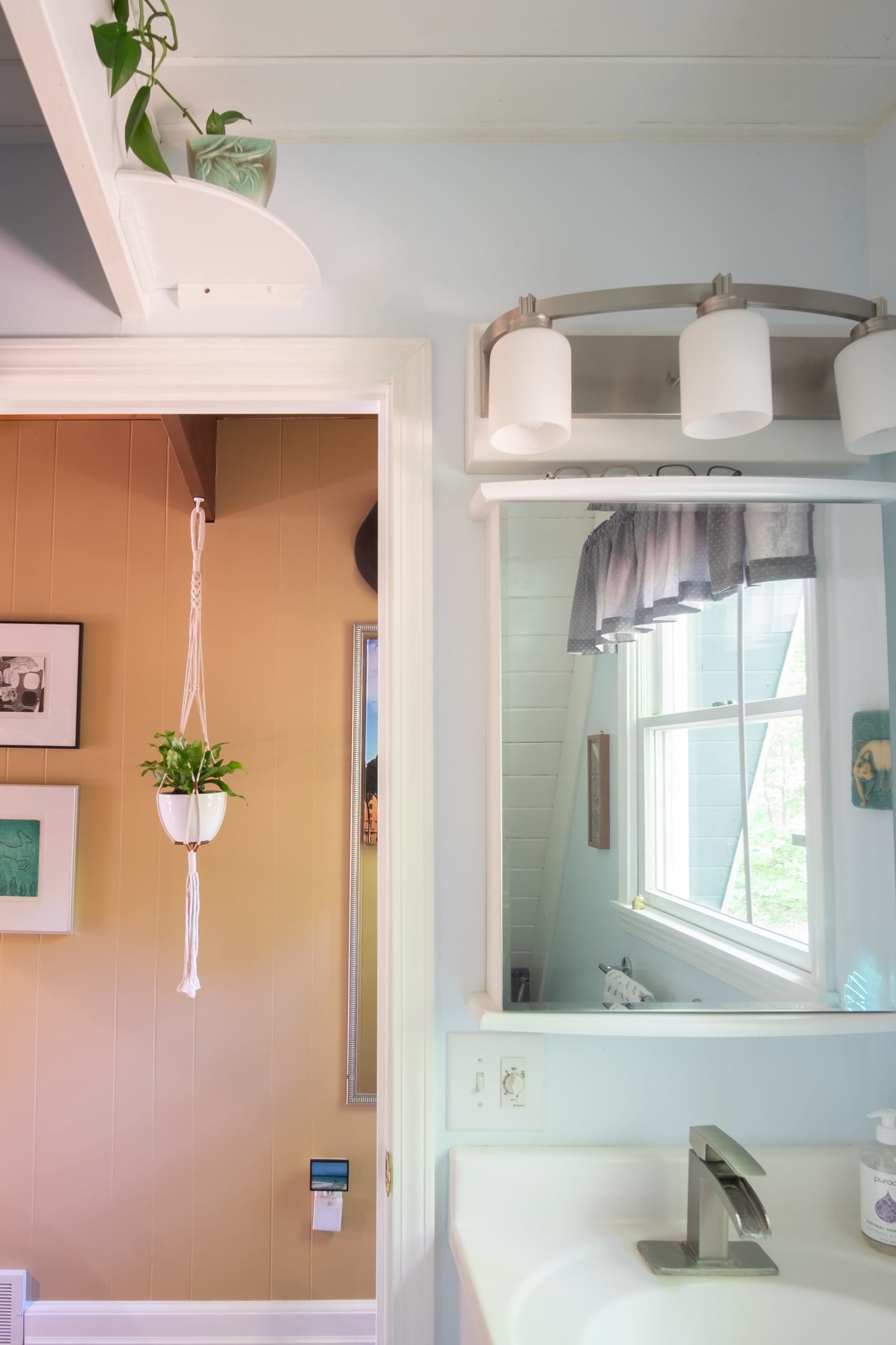 "Cozy bathroom meets warm hallway with a touch of greenery!"