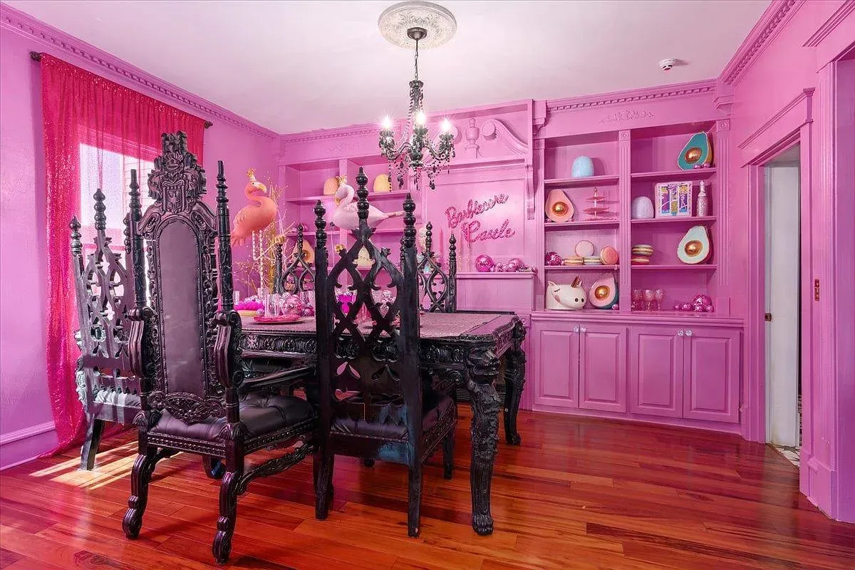 ## An exuberant pink dining area with ornate detailing and a showpiece chandelier feels over-the-top in the best way.