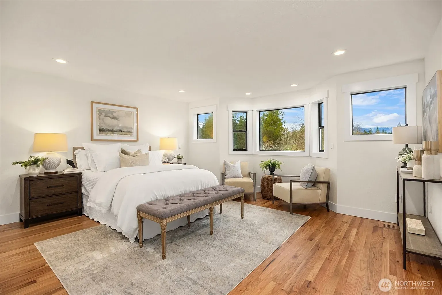 Calm bedroom, big double-hung windows, light walls. Instant deep-breath energy.