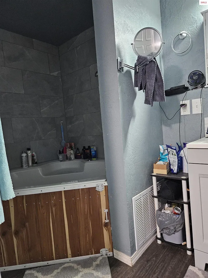 Here's the bathroom—gray tile stack in the shower. Modern, not fussy.