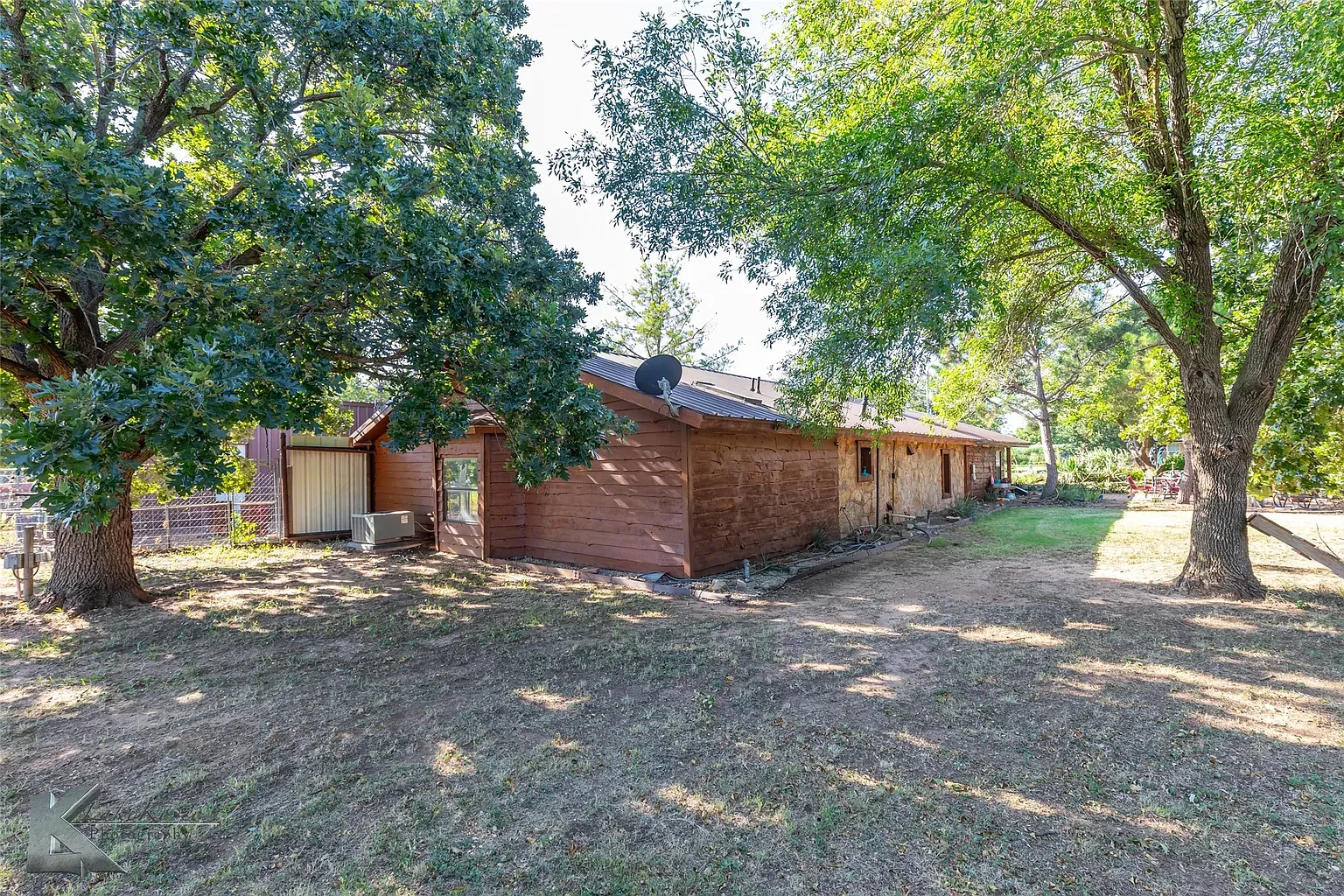 Back view is pure cabin—dark timbers, a little weather-beaten, still charming.