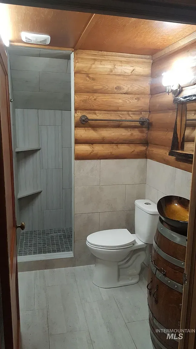 ## Light, smooth tile meets warm wood paneling—crisp and cozy in one breath, with the grain doing all the talking.
