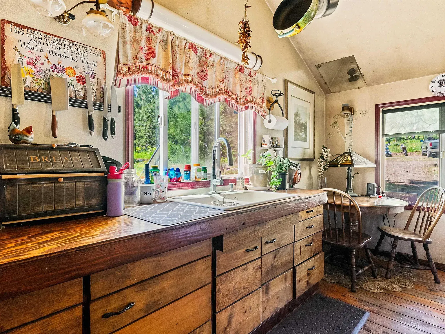 Mixed wood cabinets, dark below and lighter above with glass.