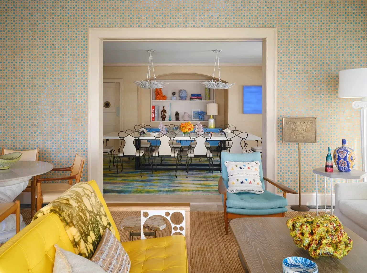 "Isn’t this dining area so inviting? I love how it opens up to the living space, and the color on the walls adds such a cheerful touch. The big table in the back is perfect for gatherings!"