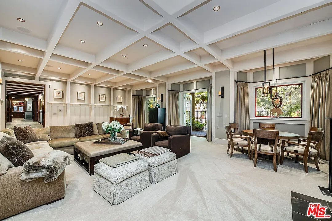 Cozy lounge zone. Beige carpet, open plan, lots of soft textures.