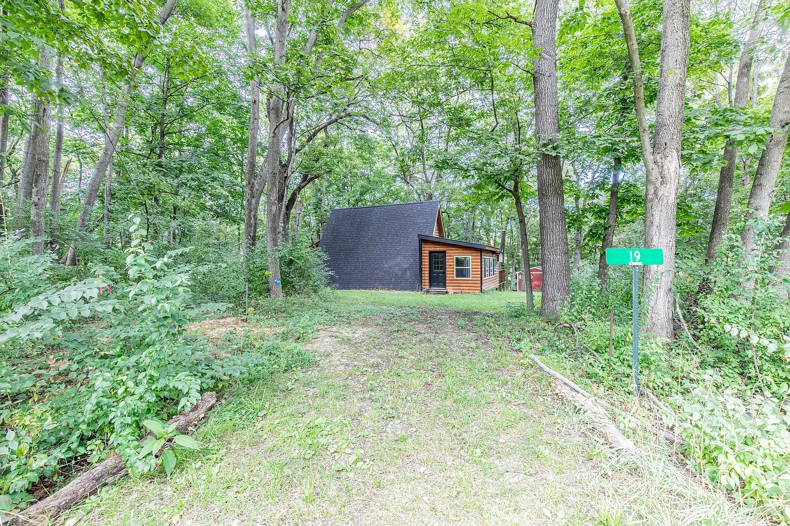 And back outside — modern cabin tucked quiet. Amazing old woman's place, right?