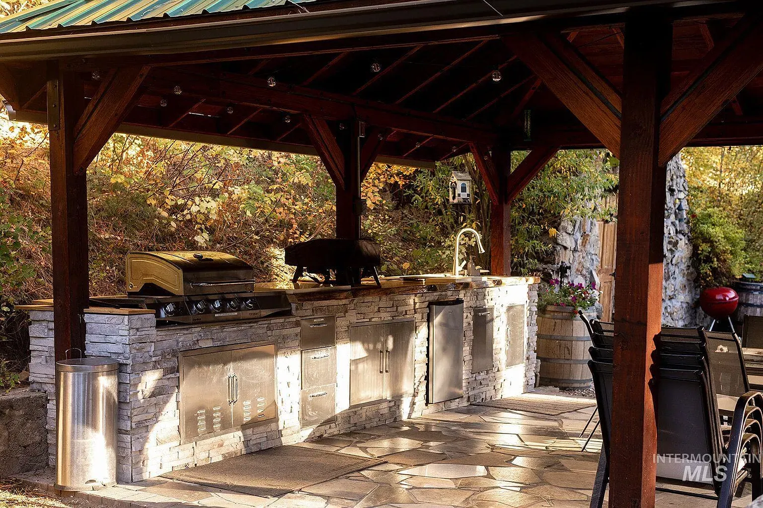 ## An expansive, earth-toned stone slab stretches wide—smooth to the touch, echoing the greens and golds around it.