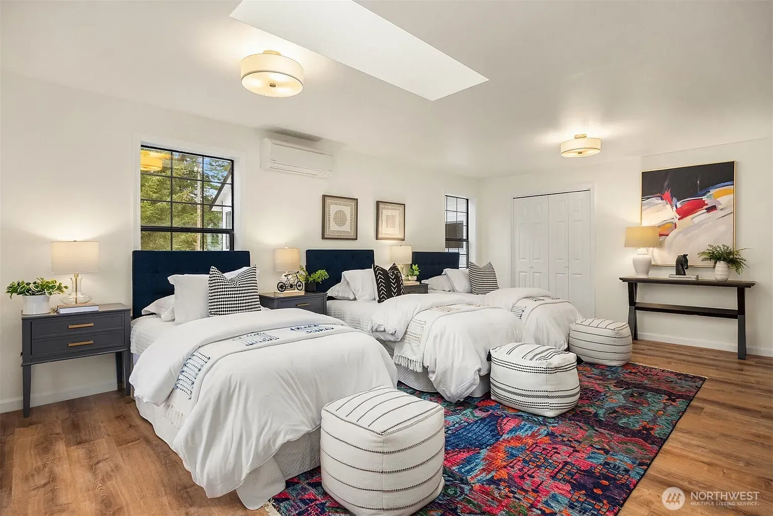 Guest room with double queens — hotel energy, but in a good way.