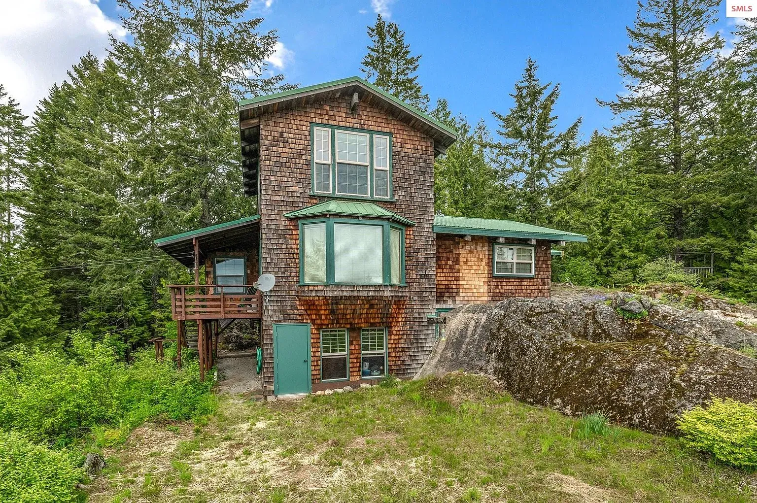 ## Natural wood shingles and that punchy green roof—fits the evergreens nicely. Not bad.