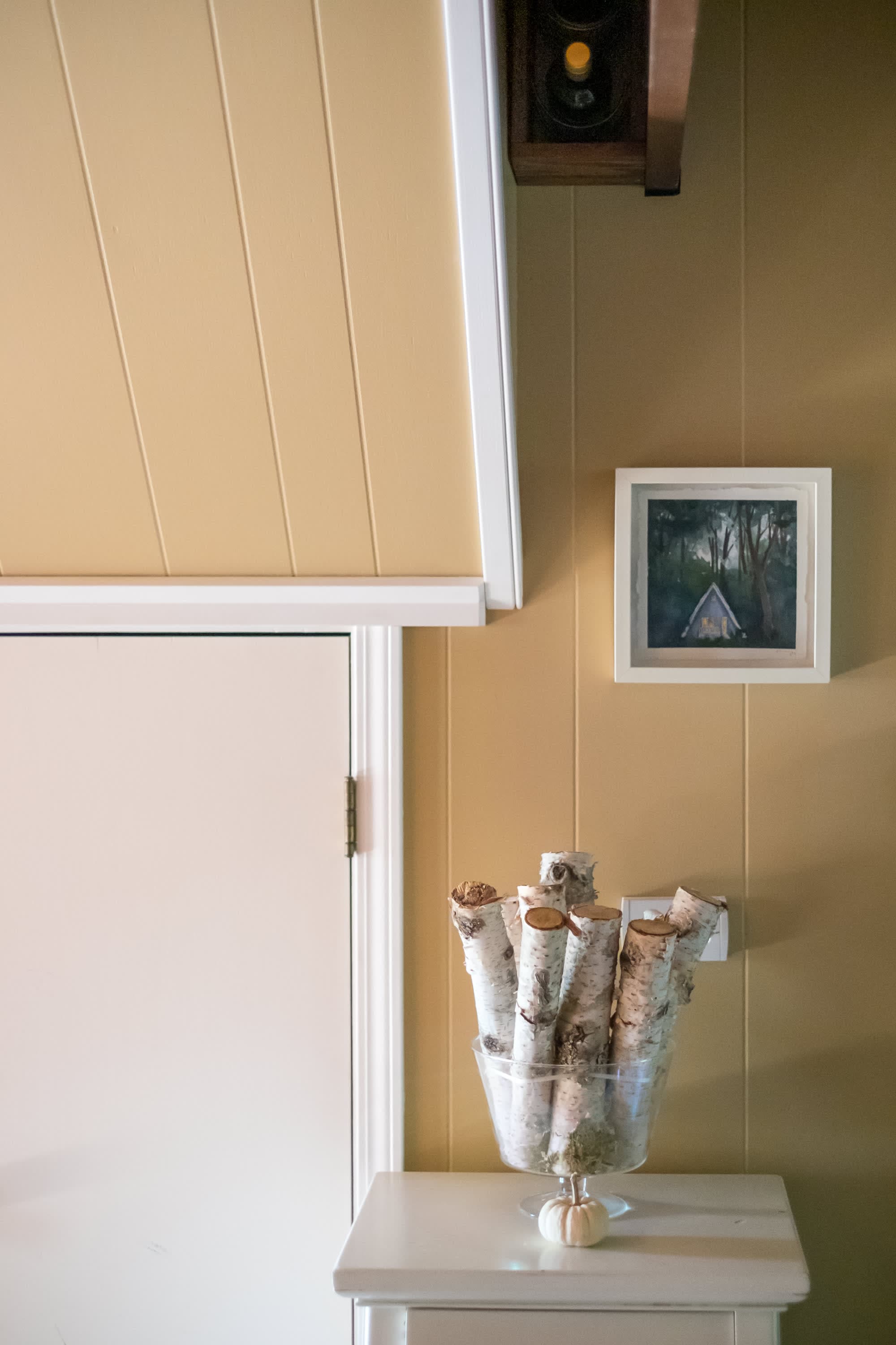 "Cozy Corner with Birch Logs and Woodland A-Frame Art"