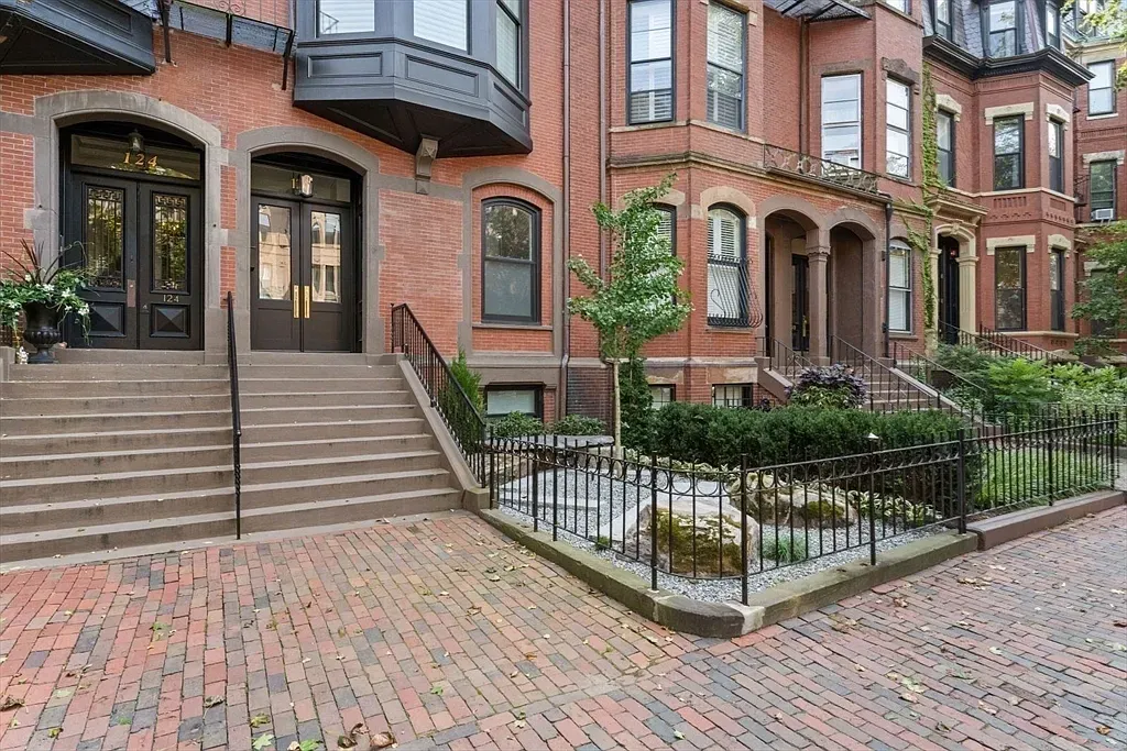 "Isn't this brick facade just charming? The steps are so inviting, and the landscaping really adds to the vibe!"