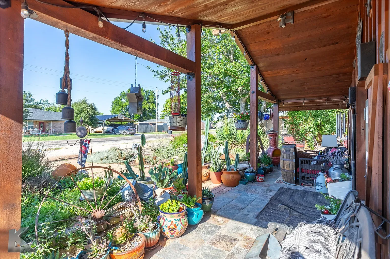 Here's the side porch—beefy beams, slate underfoot. Great shade, squeaky maybe?
