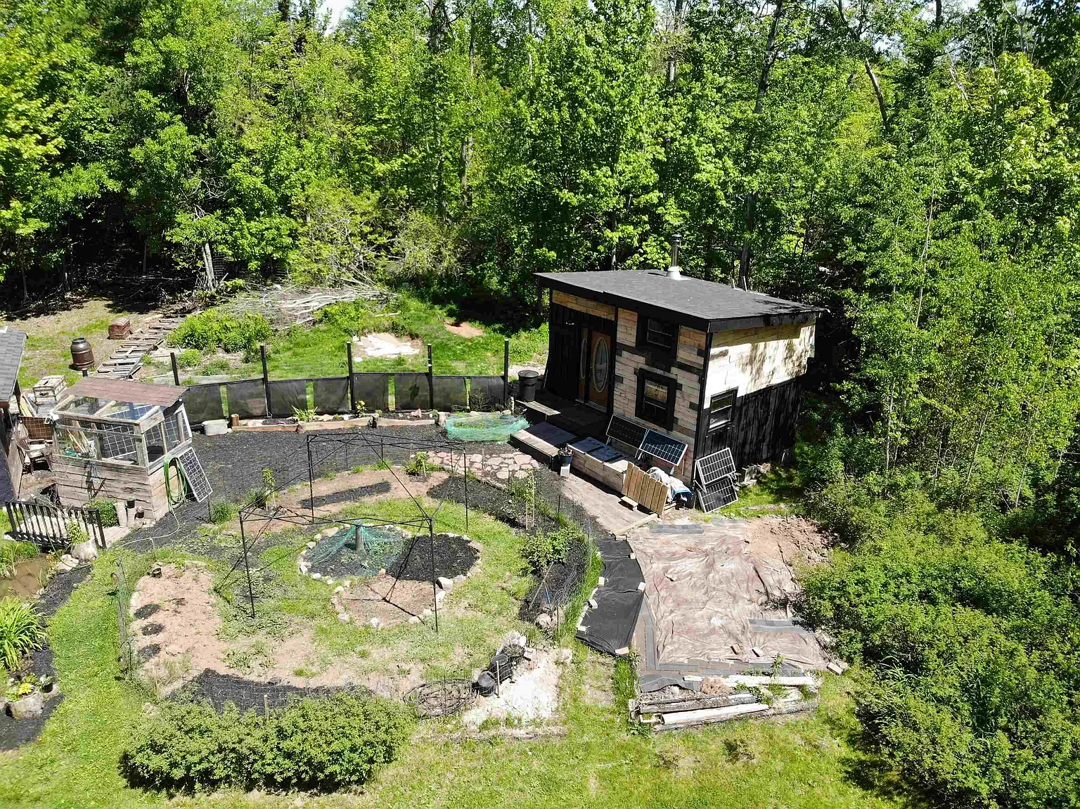 Another outbuilding? Dark siding with metal accents. Anyone know why they went black?