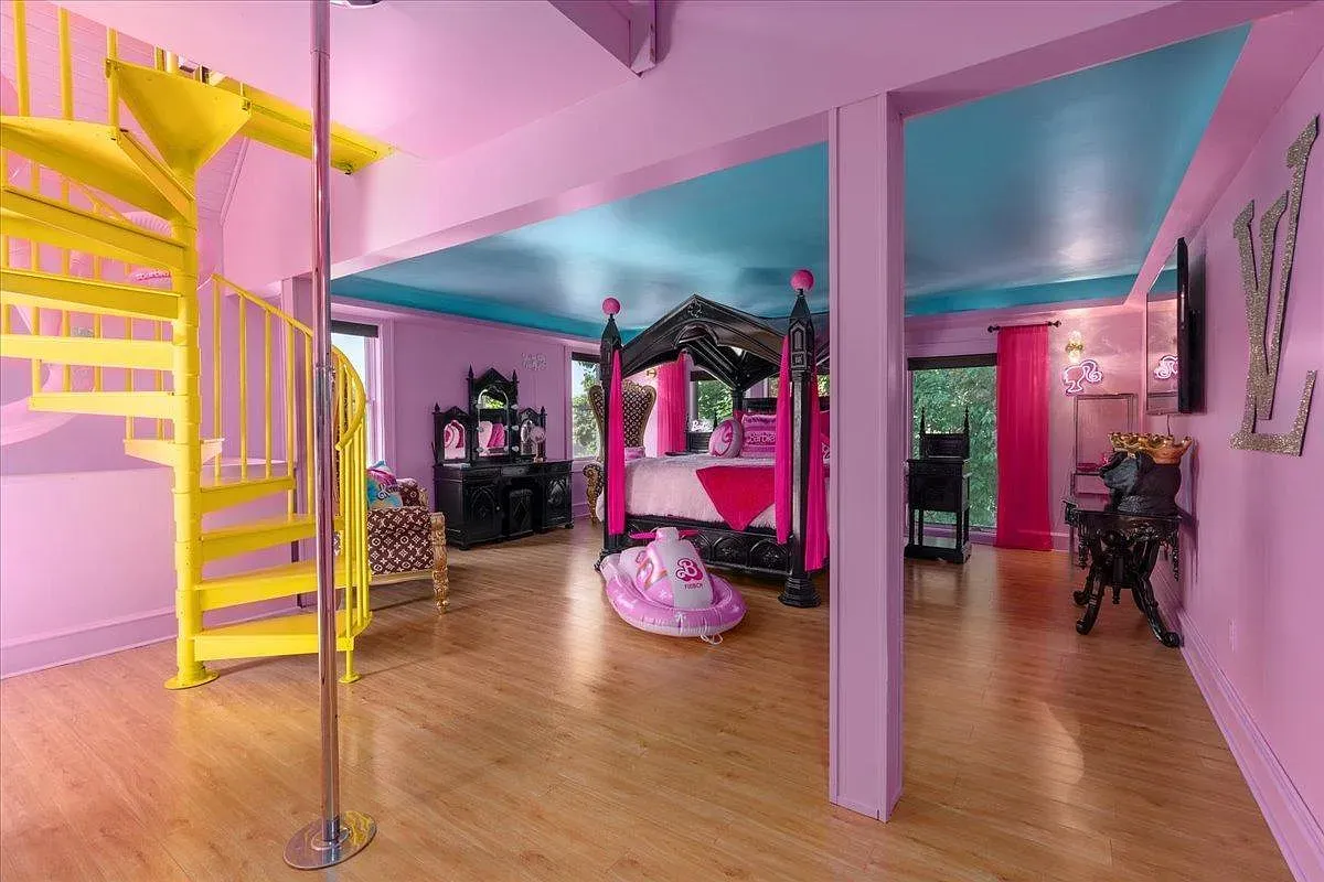 ## Pink room, bright blue ceiling, and that spiral feature steals the show—honestly a playful surprise that begs for a quick spin.