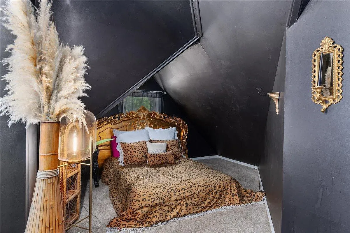 ## Charcoal attic bedroom leans moody; the sloped ceiling makes it snug, and the dark walls let lighter bedding and art really pop.