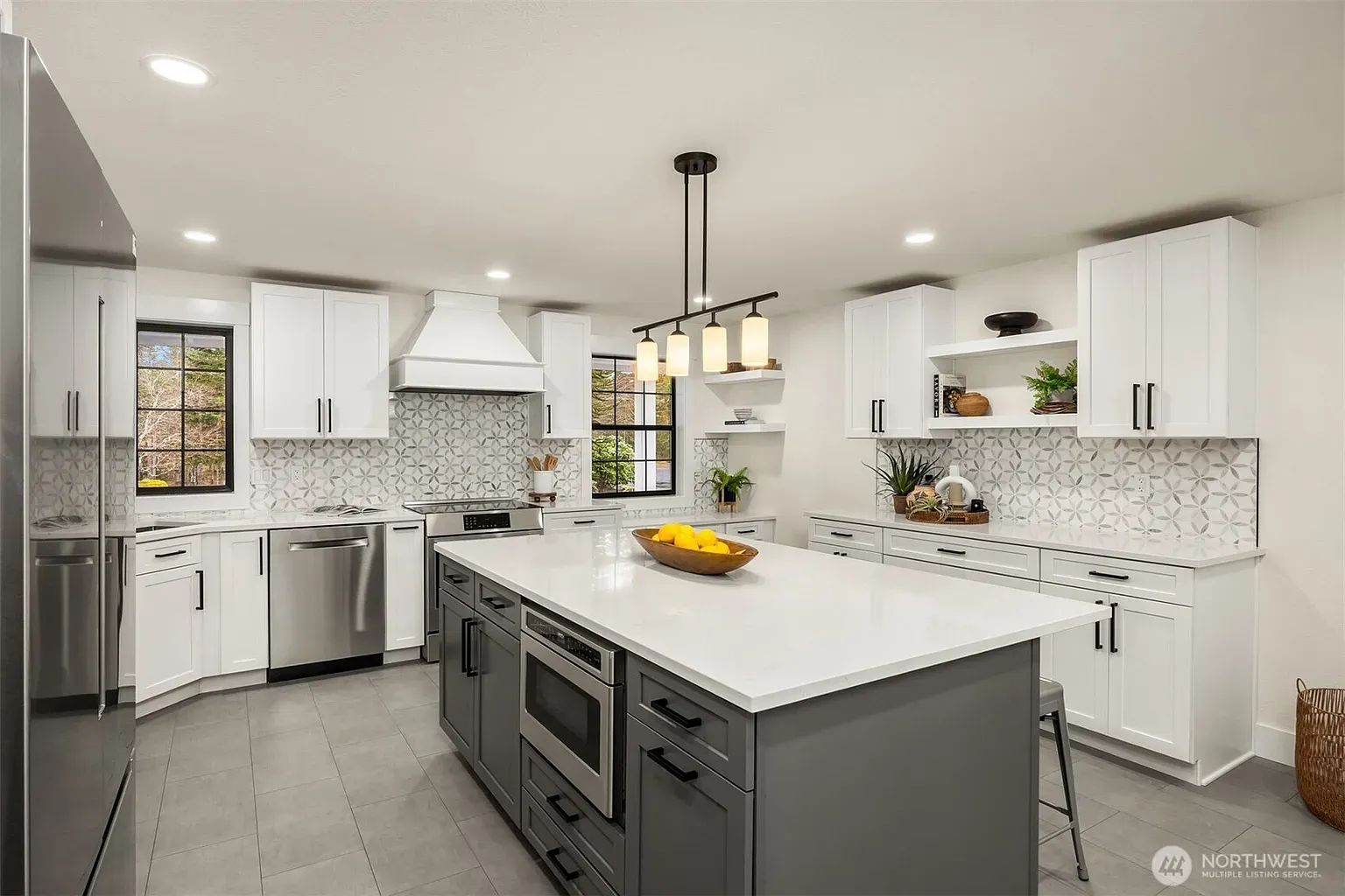 Kitchen time — white cabinets, chunky island, pendants that actually fit the scale.