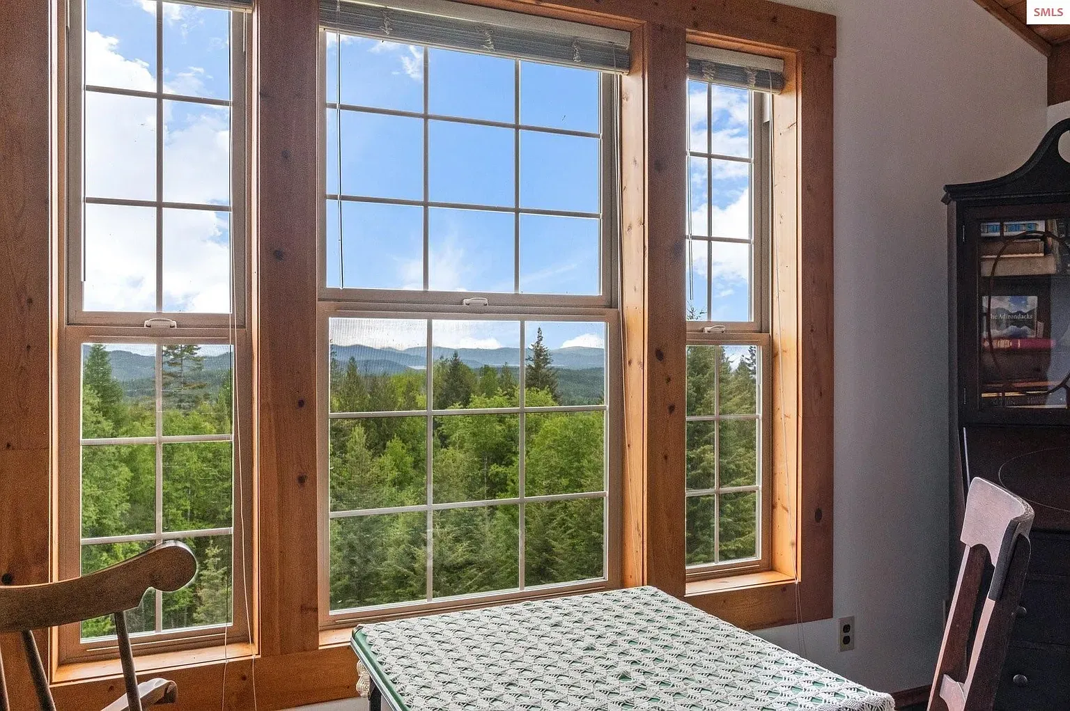 ## Big multi-pane windows, warm wood trim, and hills-to-mountains views—pretty sweet light.