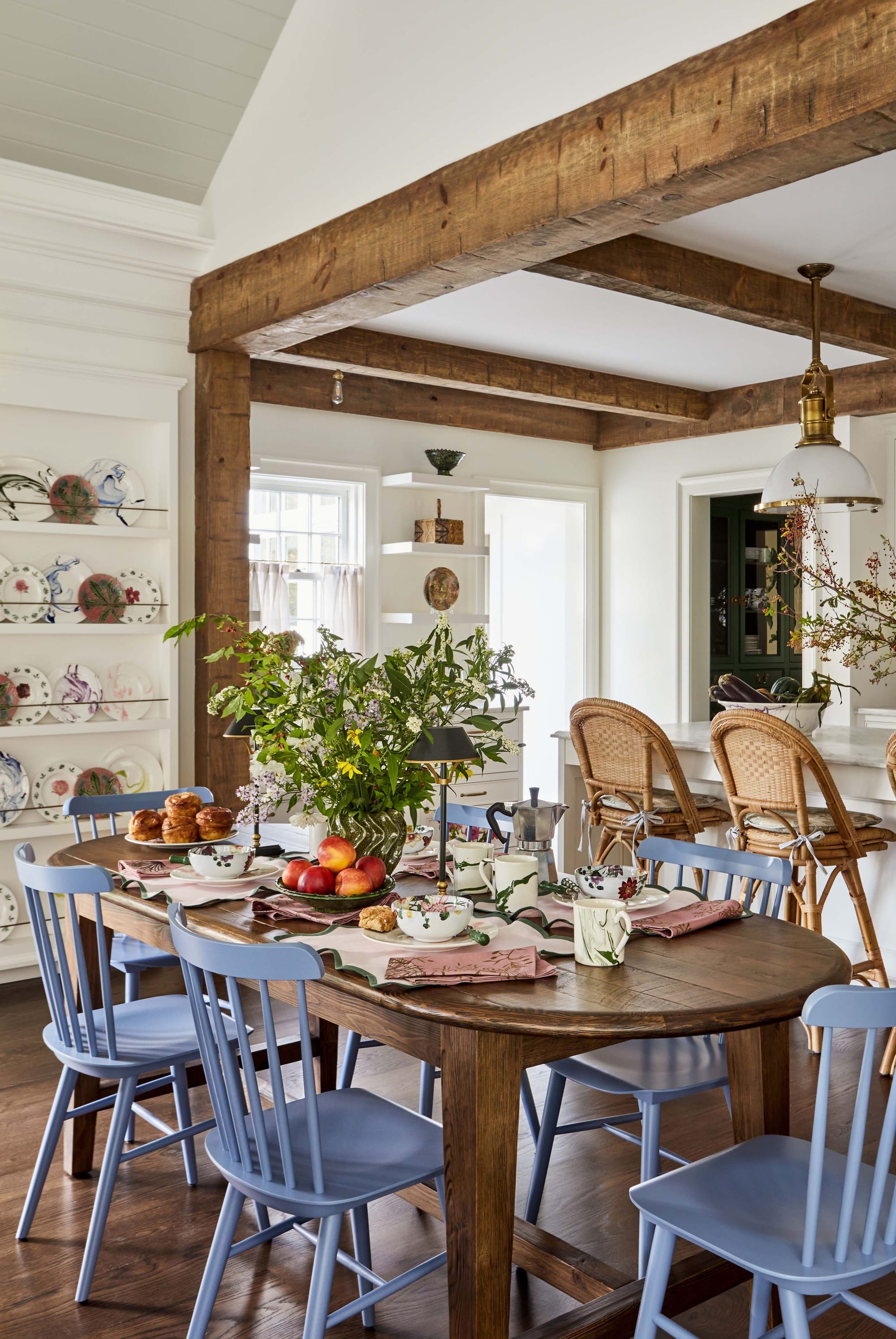 "Rustic Farmhouse Charm Meets Modern Comfort in This Beautifully Set Dining Space with Exposed Wooden Beams!"