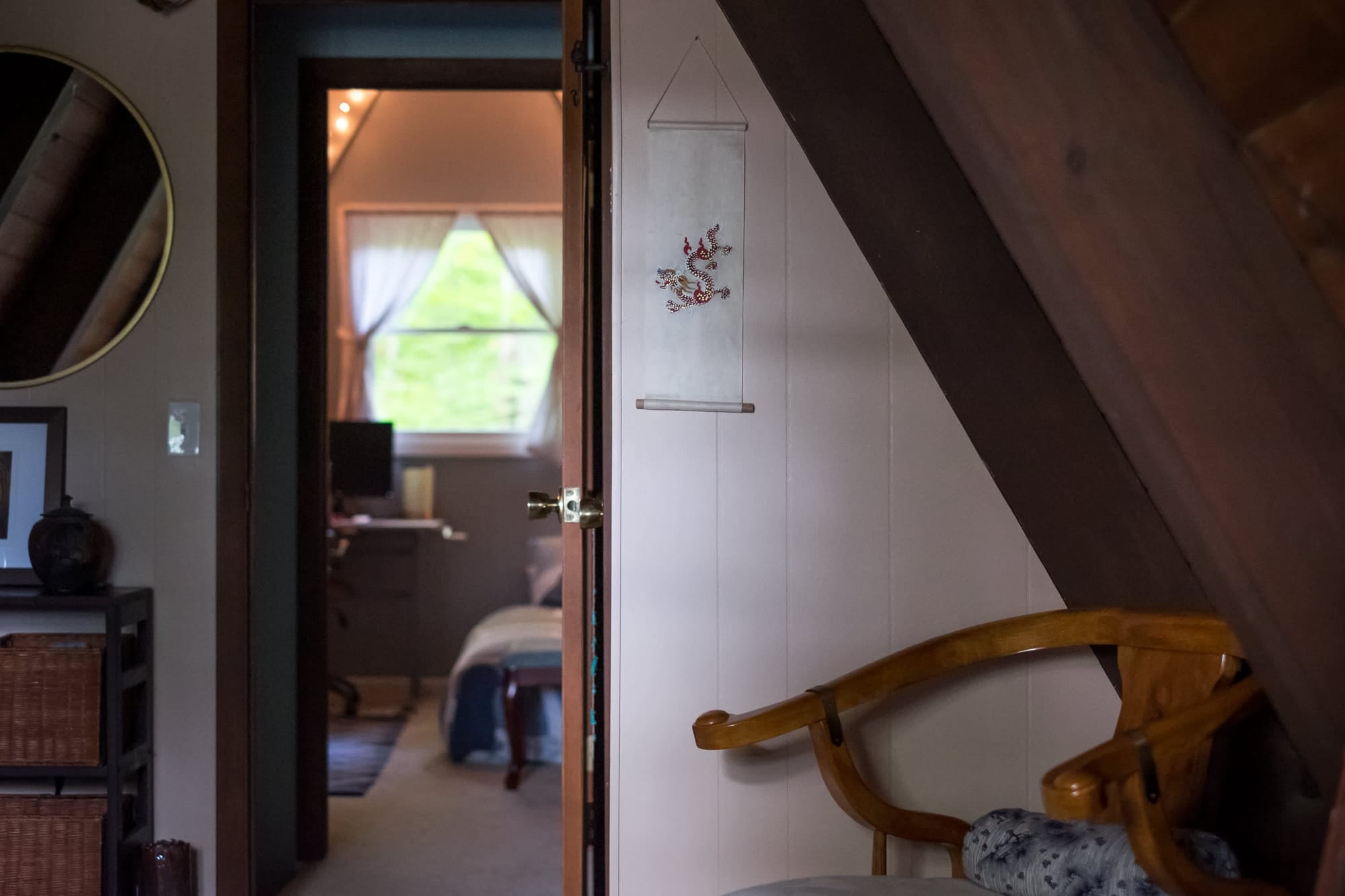 "Cozy bedroom glimpse through an open door with charming wall art!"