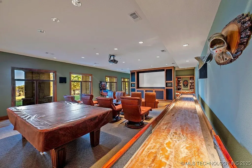 Cozy media room. Soft greens, warm wood, looks ready for late movies.