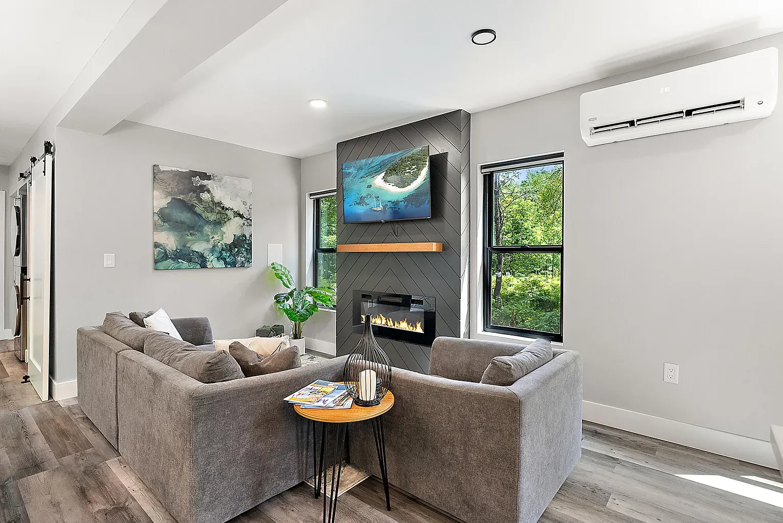 Living room again. soft gray walls, warm floors. Centerpiece looks low. media console?