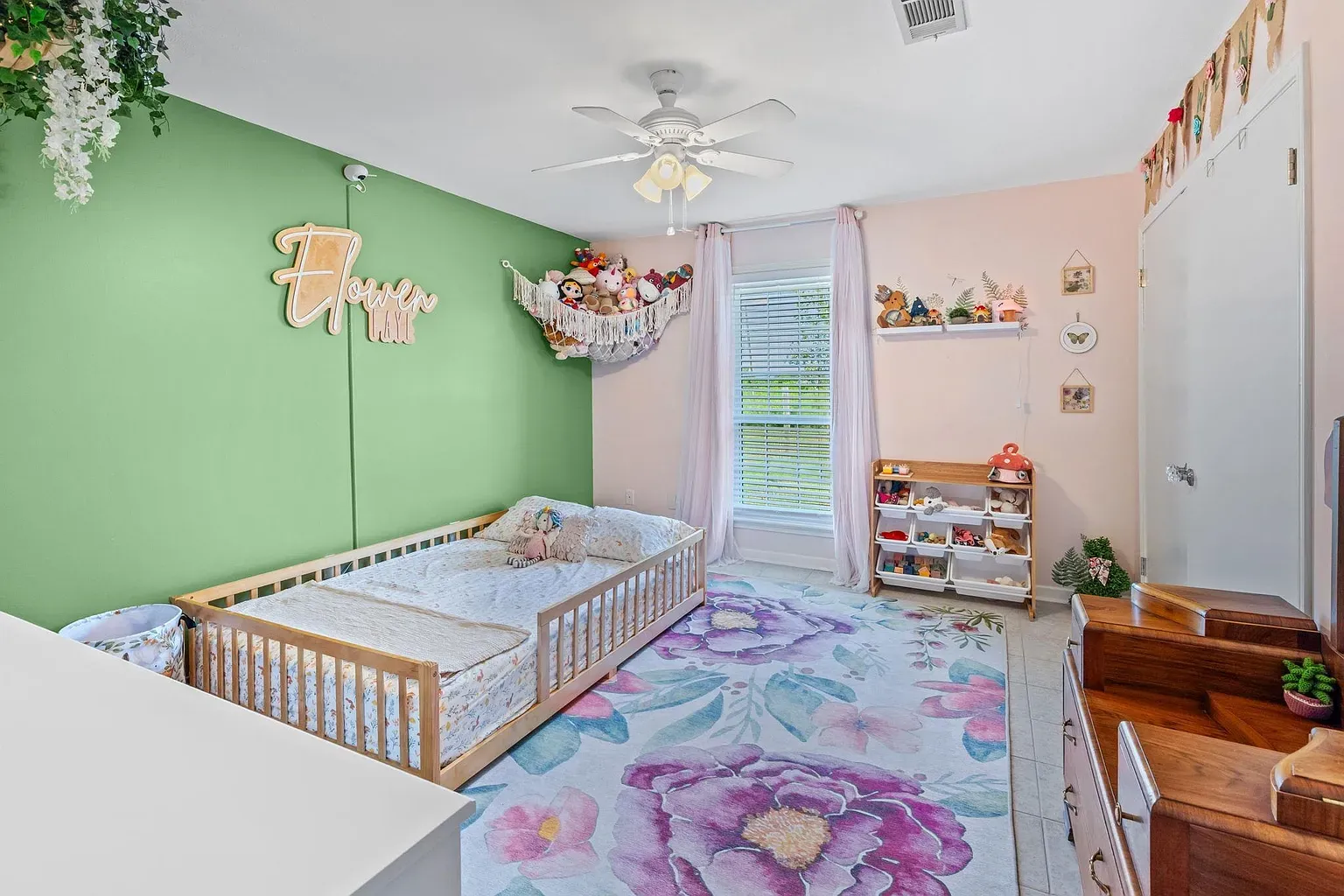 Green accent wall totally wakes this nursery up. Cute without shouting.