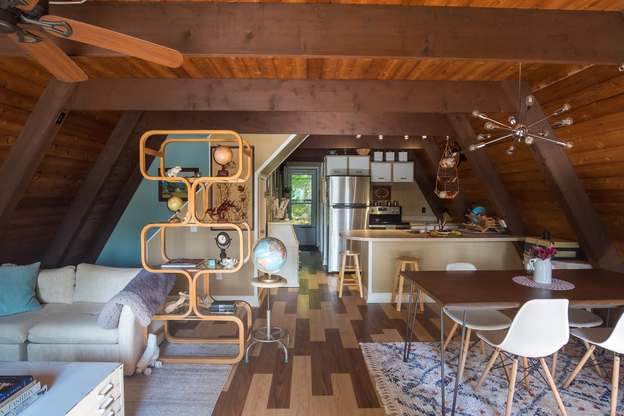 "Cozy A-Frame Living with Mid-Century Charm and Rustic Wooden Beams!"