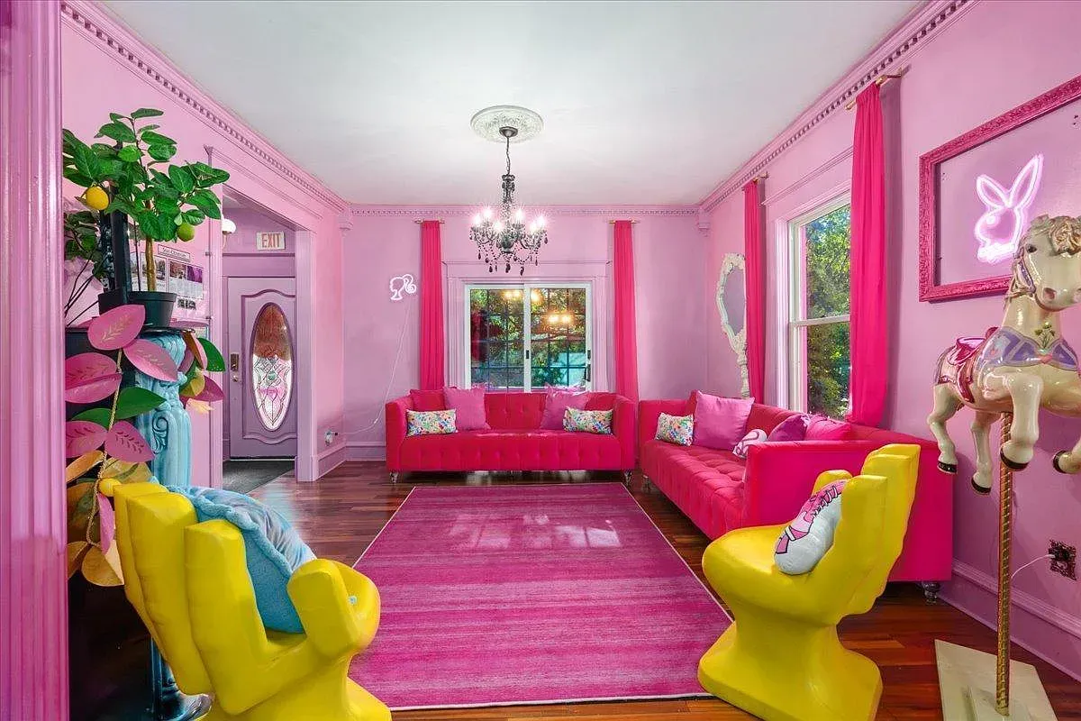 ## Living room goes full pink-on-pink; matching curtains soften the windows while daylight keeps it bright and surprisingly calm.