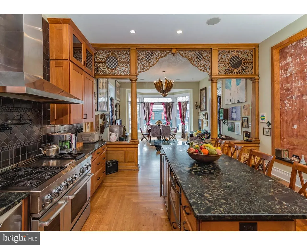 Big island, intricate woodwork—classic fancy vibes. I love it, budget says dream.