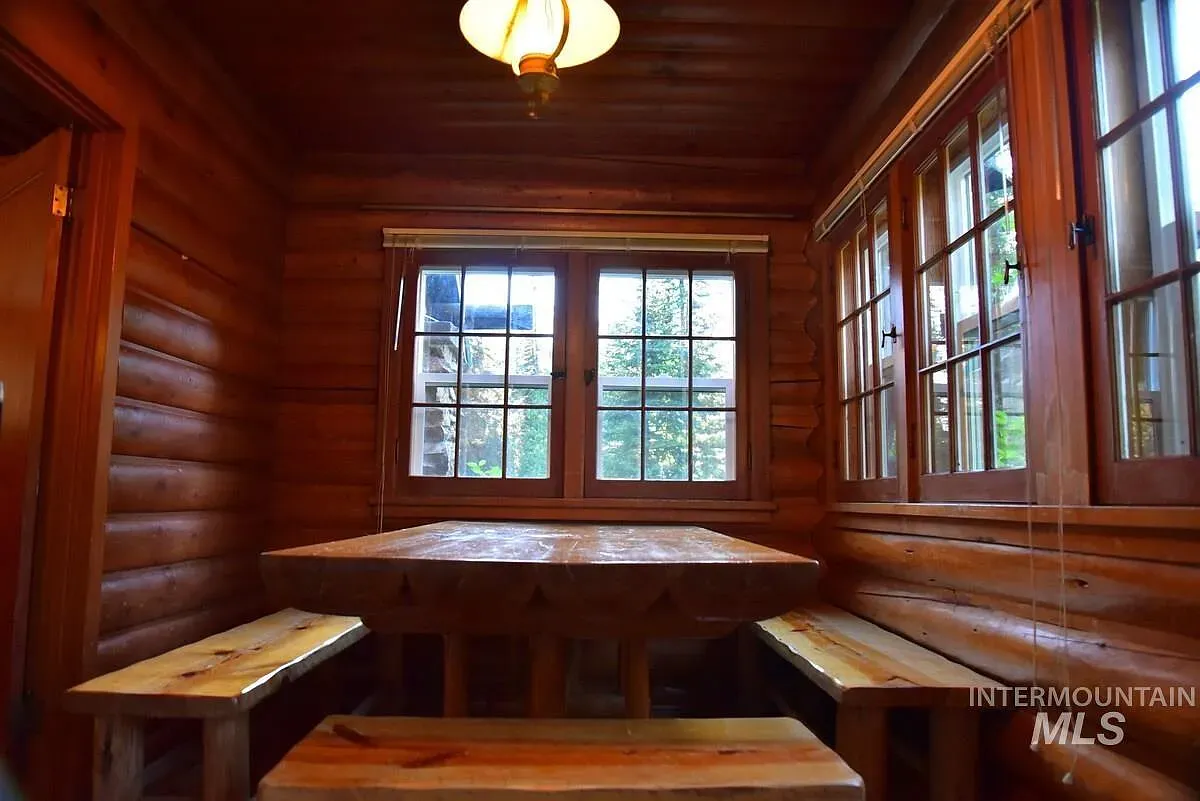 ## Big multi-paned windows pour in daylight; beams and log walls glow while the view steals the moment.