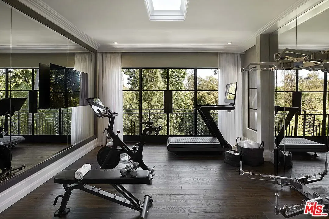 Gym goals—floor-to-ceiling windows, trees for cardio buddies.