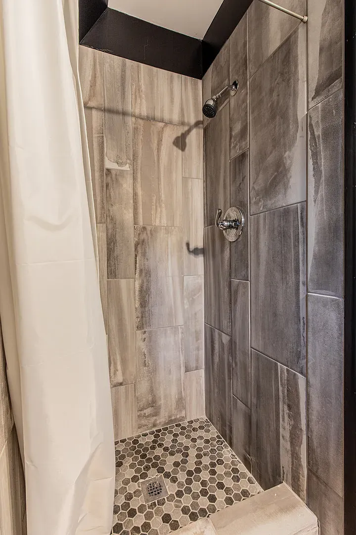 Shower looks gray wood planks. Spa mood without trying.